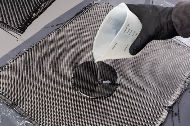 istock Rolls with various real woven carbon fiber enforcement raw material cloth. composite material automotive and car tuning  industry  high tech background. 2154138125