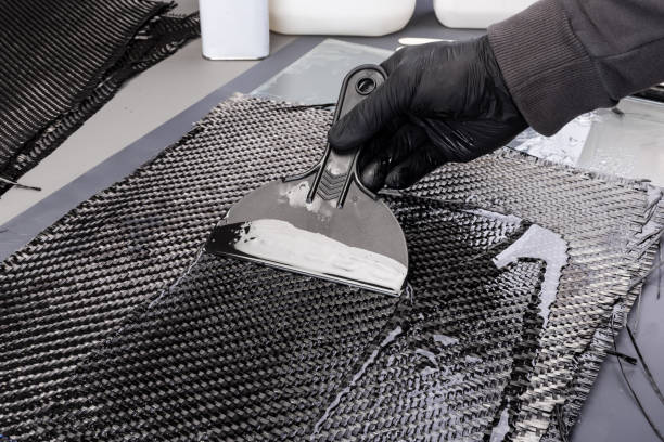 Rolls with various real woven carbon fiber enforcement raw material cloth. composite material automotive and car tuning  industry  high tech background.