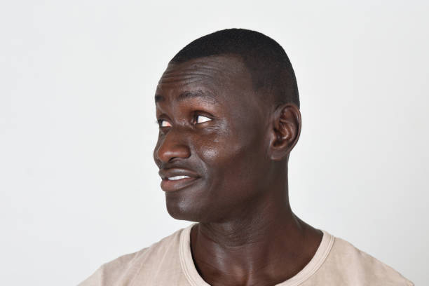 side view of a portrait of a man looking away on white background