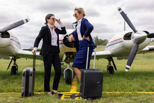 istock Two stewardesses in front of an airplane 2154139750