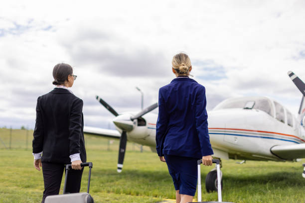 istock Two stewardesses in front of an airplane 2154139766