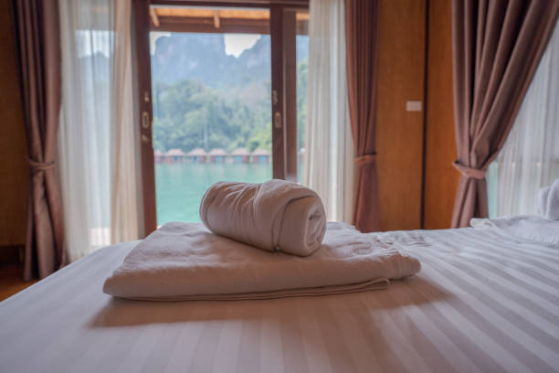Close up shot of the white towels rolled in the massage couch