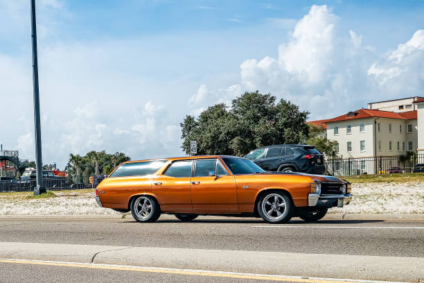 A sepia-toned photograph of a really well-done muscle car in brown tone  with spot color
