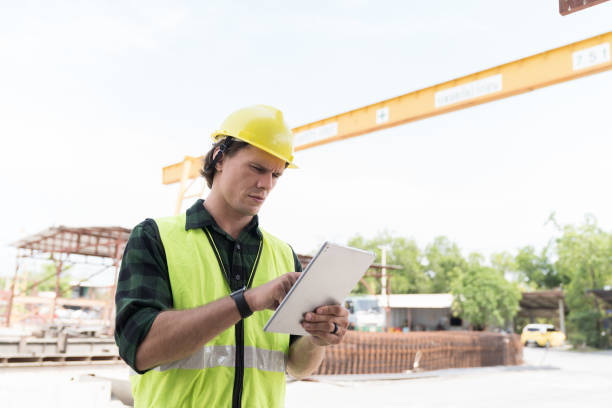 istock Male engineer construction working and inspecting structure of building with digital tablet at construction site. Male construction builder working at construction site 2154150693