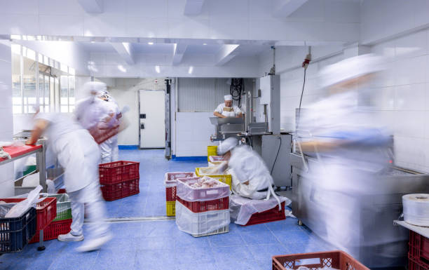Group of Latin American employees working at a busy butcher's shop - time lapse concepts