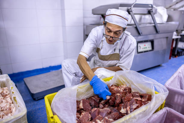 istock Employee working at the butcher's shop sorting the meat 2154154910