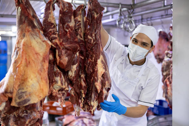 istock Butcher working at the slaughter house sorting meat 2154154963