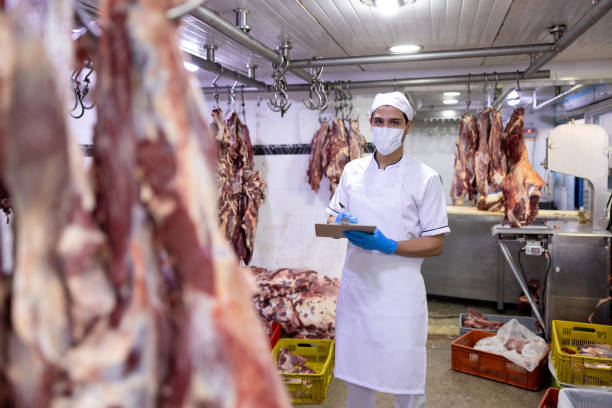 istock Inspector doing quality control on the meat at the butcher's shop 2154155008