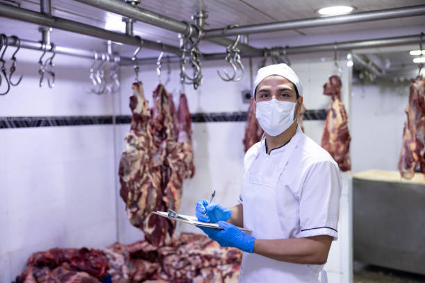 istock Employee doing quality control at the butcher's shop 2154155012