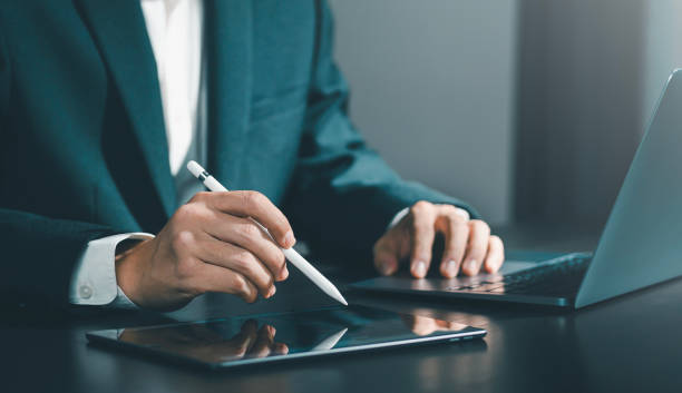istock Businessman using laptop computer and digital tablet on table surfing the internet. Working online. Remote work. remote working concept independent lifestyle 2154155040