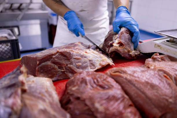 istock Close-up on a butcher cutting meat 2154155047