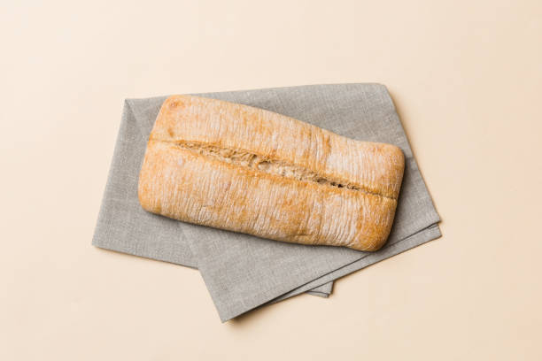istock Fresh ciabatta bread on napkin on rustic background, Italian bread top view 2154155258