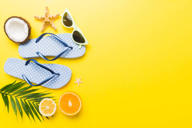 istock Top view composition of flip flops placed with beach accessories top view on table background. Tropical summer vacation concept Flat lay 2154155309