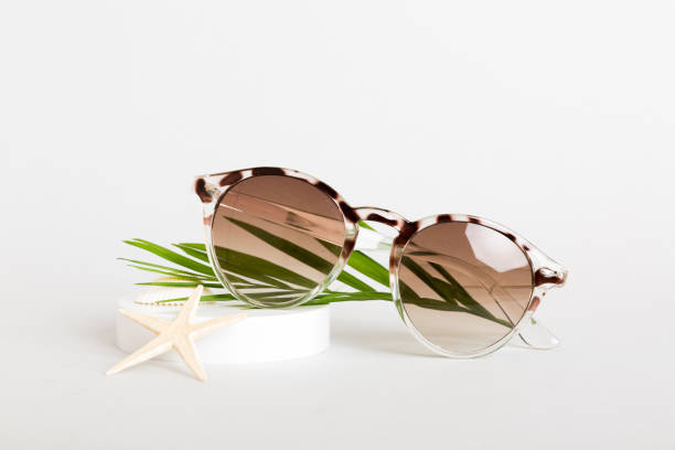 istock sunglasses with seashell lying on table background. Sunglasses on summer background. Top view flat lay with copy space for text 2154155332