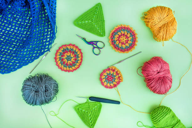 istock Layout of crochet patterns, multicolored balls of yarn, hooks and scissors. 2154155583