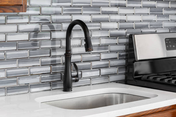 istock A rubbed bronze kitchen faucet with a glass subway tile backsplash. 2154156488