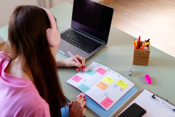 istock Young woman planning schedule with colorful calendar 2154157126