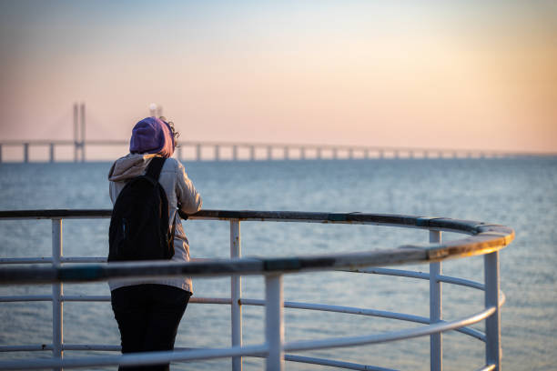 istock Beautiful woman is looking at view at sunset. 2154158124