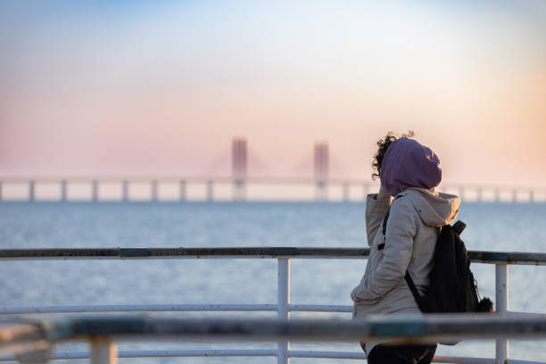 Beautiful woman is looking at view at sunset.