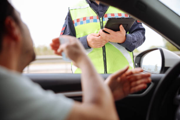 istock Policeman in uniform traffic control to male driver 2154159656