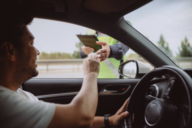 istock Policeman in uniform traffic control to male driver 2154159826