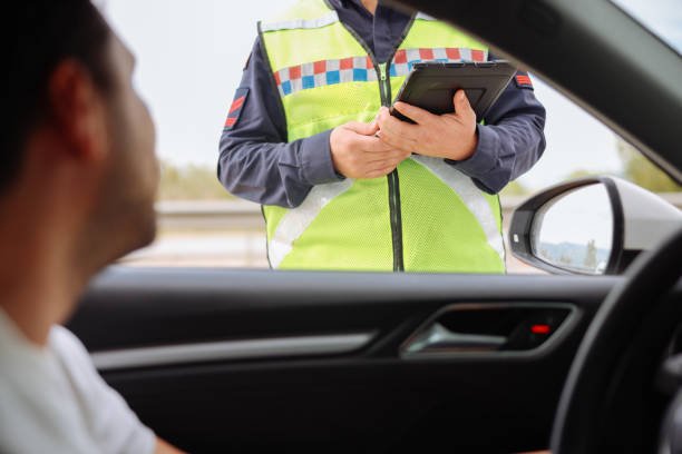 istock Policeman in uniform traffic control to male driver 2154160284