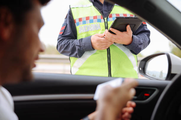 istock Policeman in uniform traffic control to male driver 2154160343