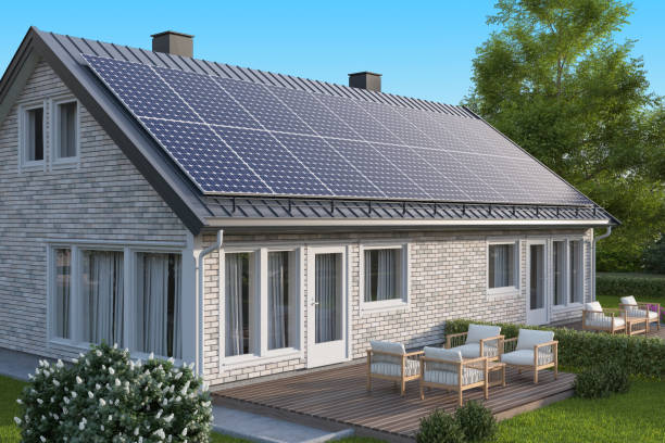 istock Solar Panels on a Metal Gray Roof of Modern White Brick House 2154169607