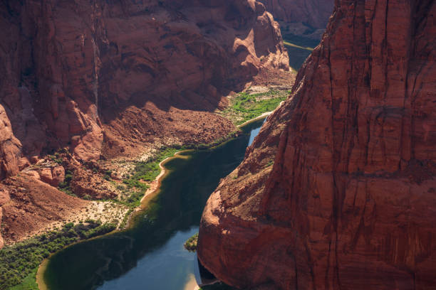 The Colorado River cuts through dramatic vermillion cliffs in Glen Canyon