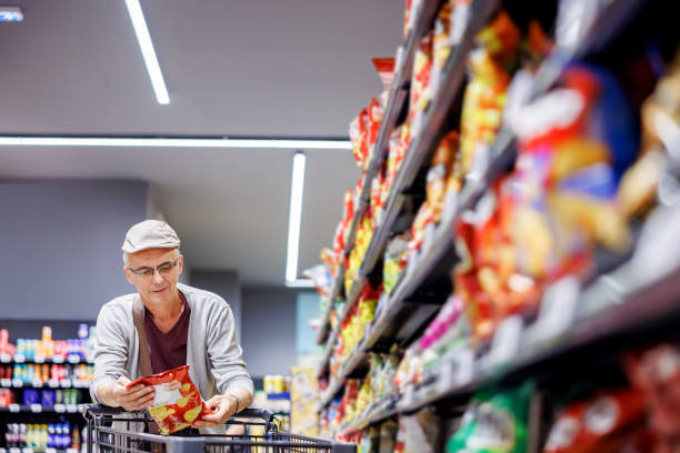istock Mature man buying snacks in market 2154172780