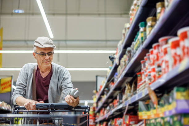 istock Smiling older man choosing products in supermarket 2154172845