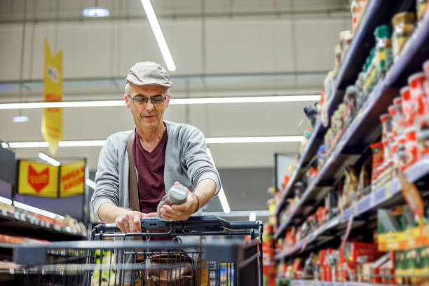 istock Older man choosing products in supermarket 2154172849