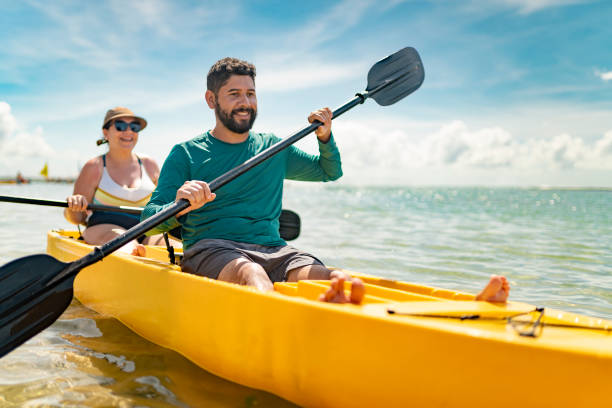 Couple kayaking on tropical beach