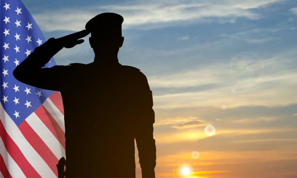 istock Silhouette of a soldier with USA flag 2154173569