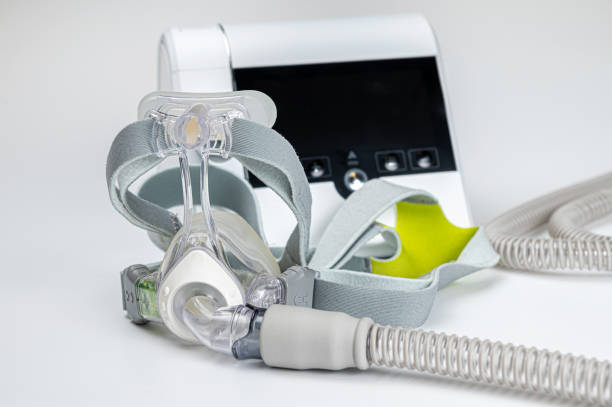 istock Continuous positive airway pressure system includes of CPAP machine, mask, tube on white background. 2154174504