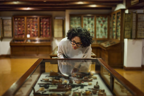 istock Woman visitor in the historical museum looking at art object. 2154176237