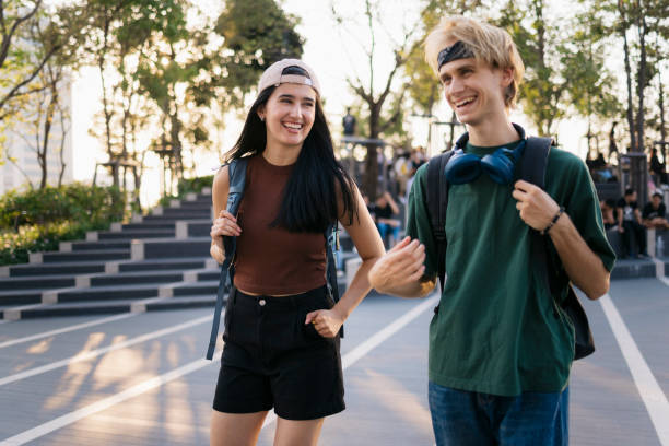 istock Cheerful young university students walking together on campus after class 2154176760
