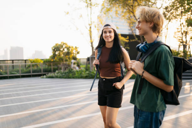 istock Happy college students walking together outdoors in the city 2154177005