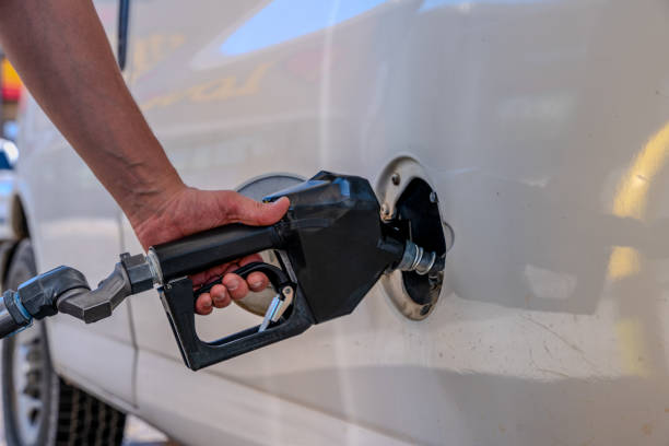 istock Hand Refilling the Car with Fuel at the Refuel Station 2154177108