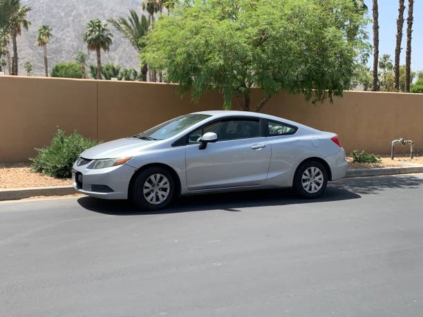 Honda Silver Honda Civic parked outside on the street 2012 stock pictures, royalty-free photos & images