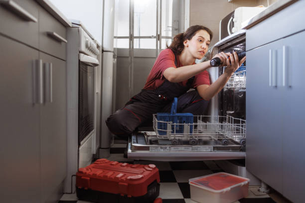 istock A young woman repairs the dishwasher 2154180340