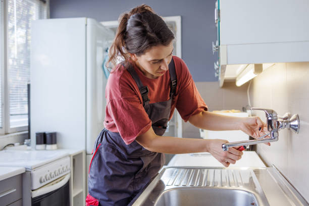 istock A Handywoman installing a faucet in the kitchen 2154180377