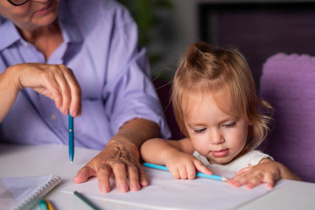 istock the girl is coloring at the table 2154182003