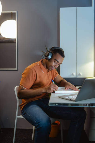 istock Young man concentrating on work. Working late at home 2154184437