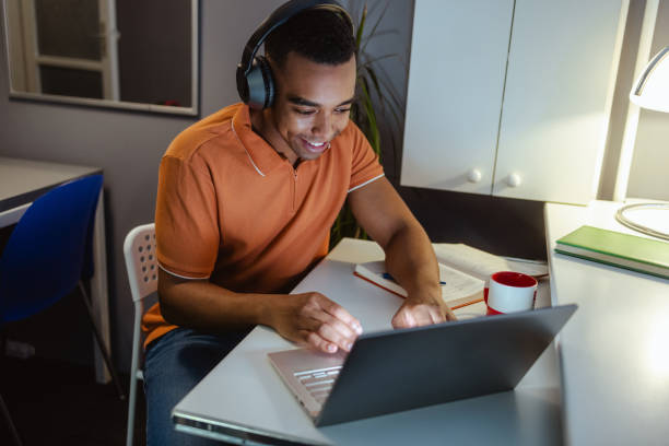 istock Young man concentrating on work. Working late at home 2154184589