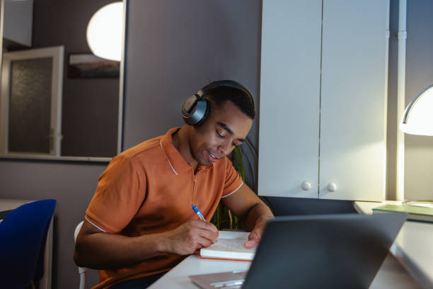 istock Young man concentrating on work. Working late at home 2154184917