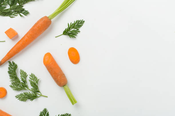 istock Flat lay with fresh carrots and leaves on white background, top view 2154185832
