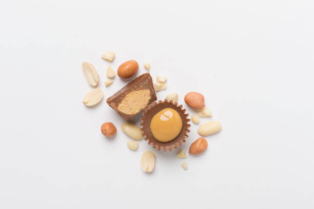 istock Tasty chocolate peanut butter cups on color background, top view 2154186492