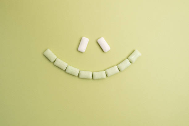 Bubble gum smile on a white background, top view frame. Chewing gum, dragee
