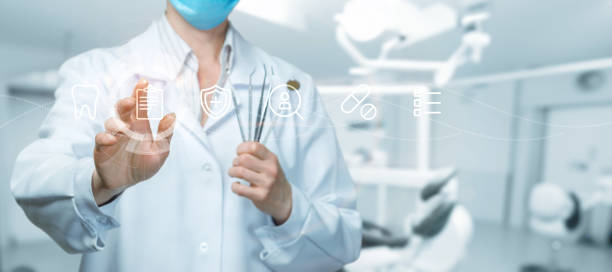 istock Dentist clicks on icon on blurred clinic background. 2154187372